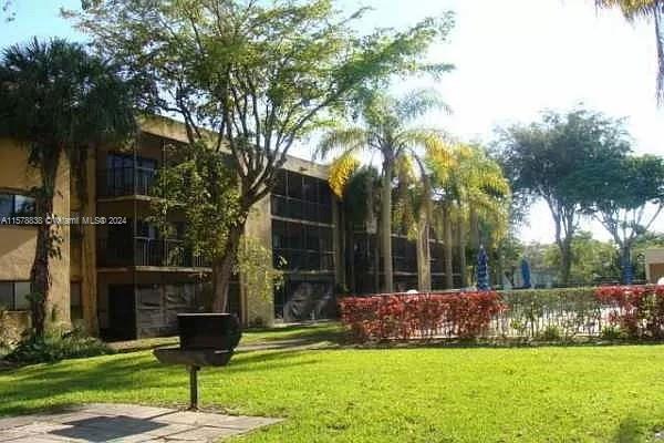 a garden with trees in front of it