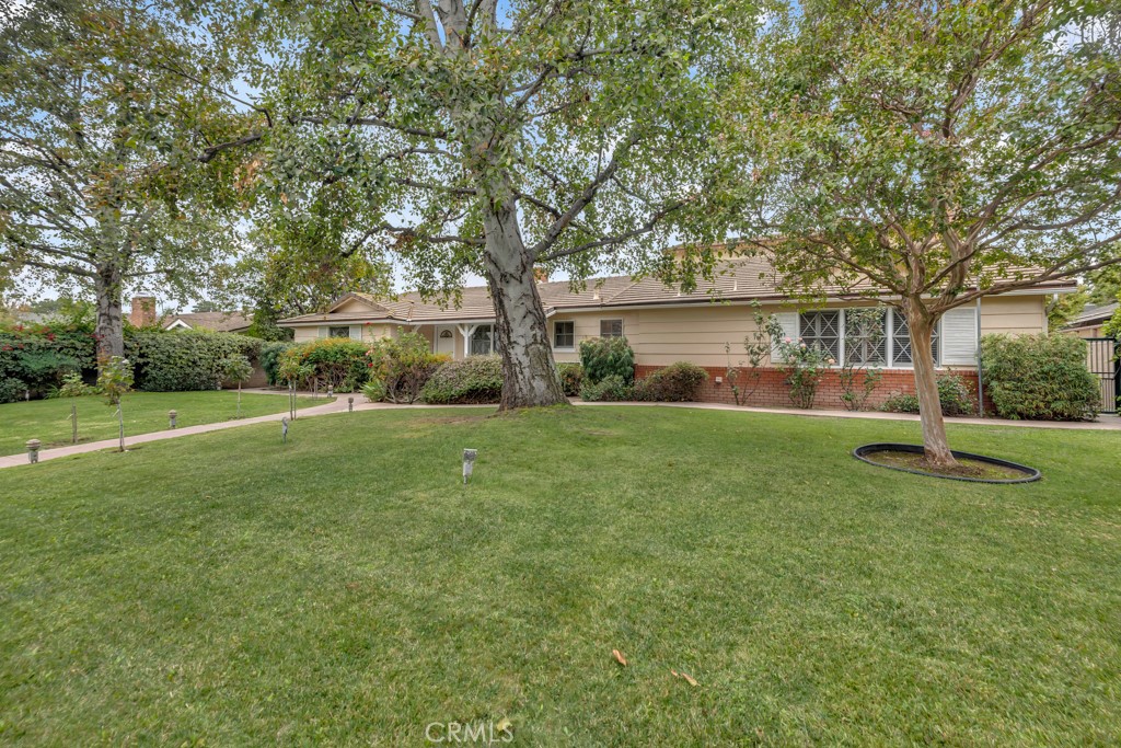 a view of house with backyard