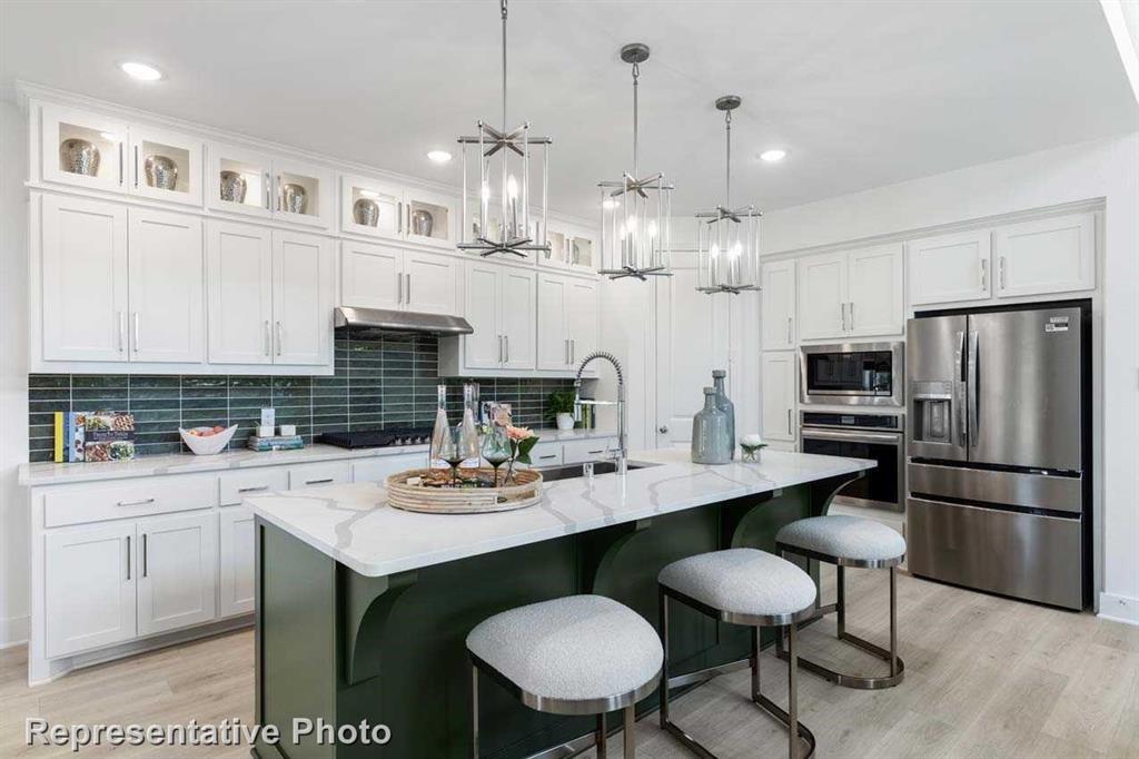 a kitchen with cabinets and stainless steel appliances