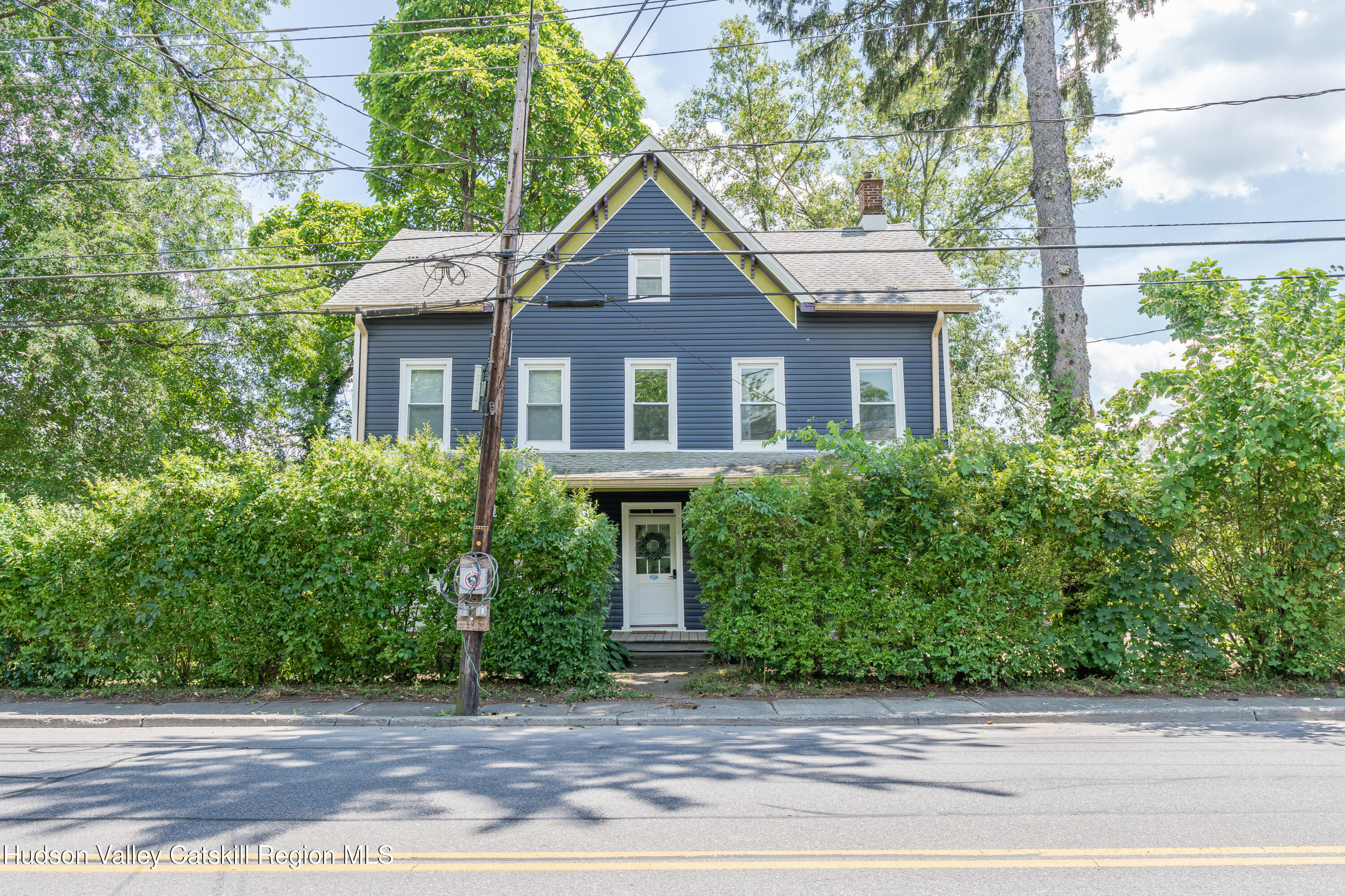 a front view of a house with a garden