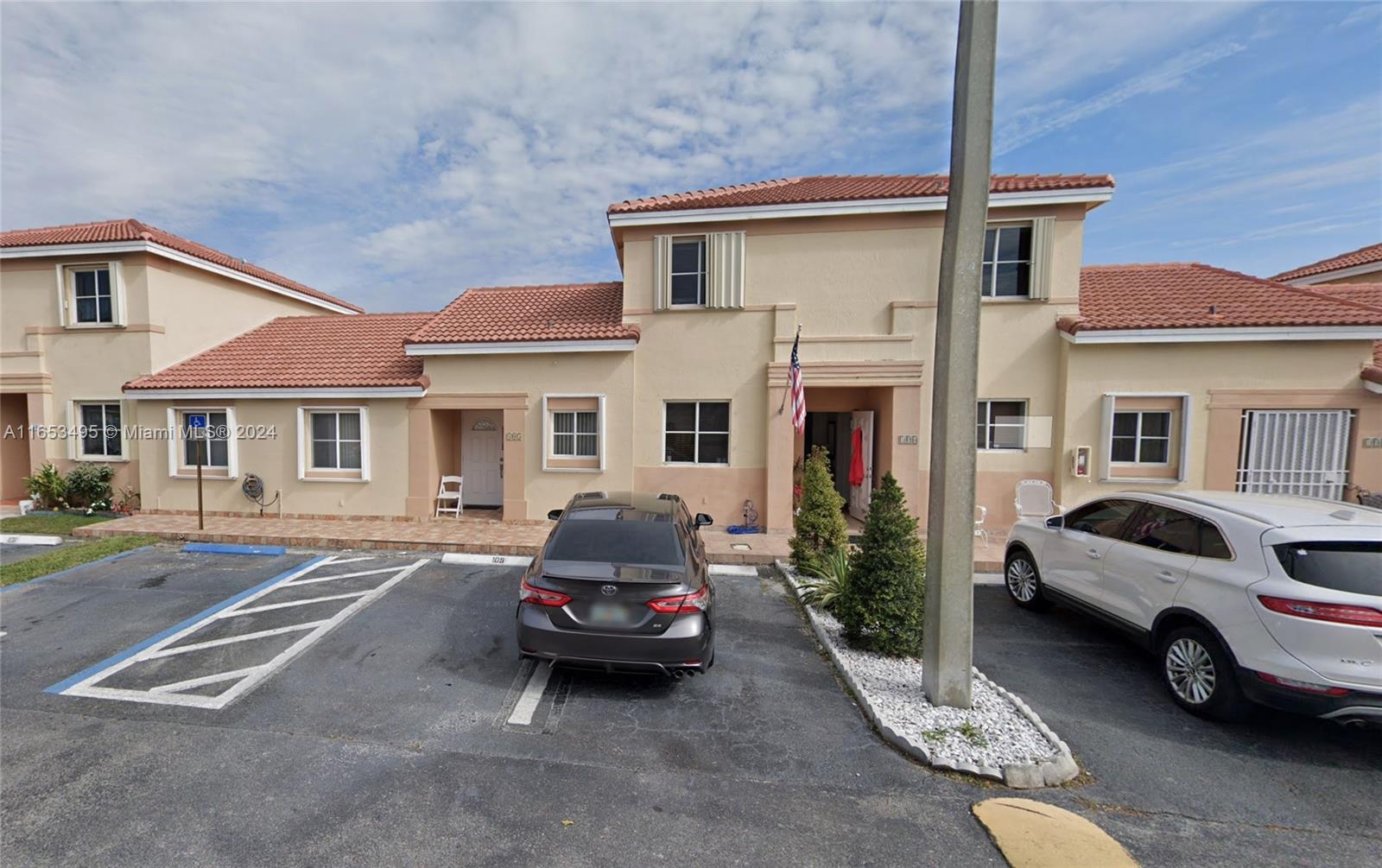 a view of a car park in front of house