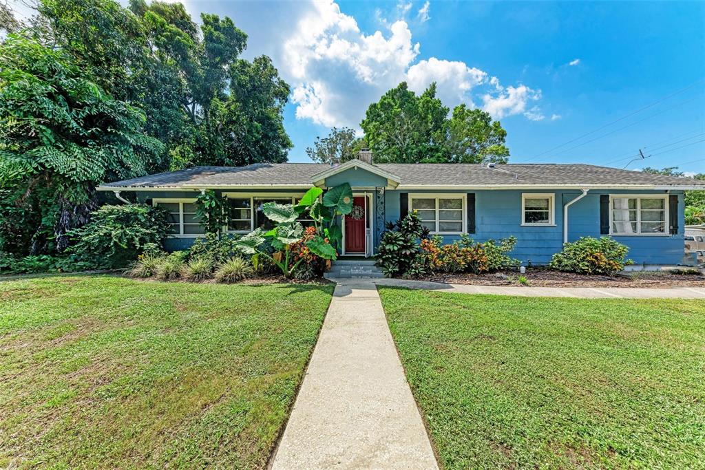 a front view of house with yard and green space