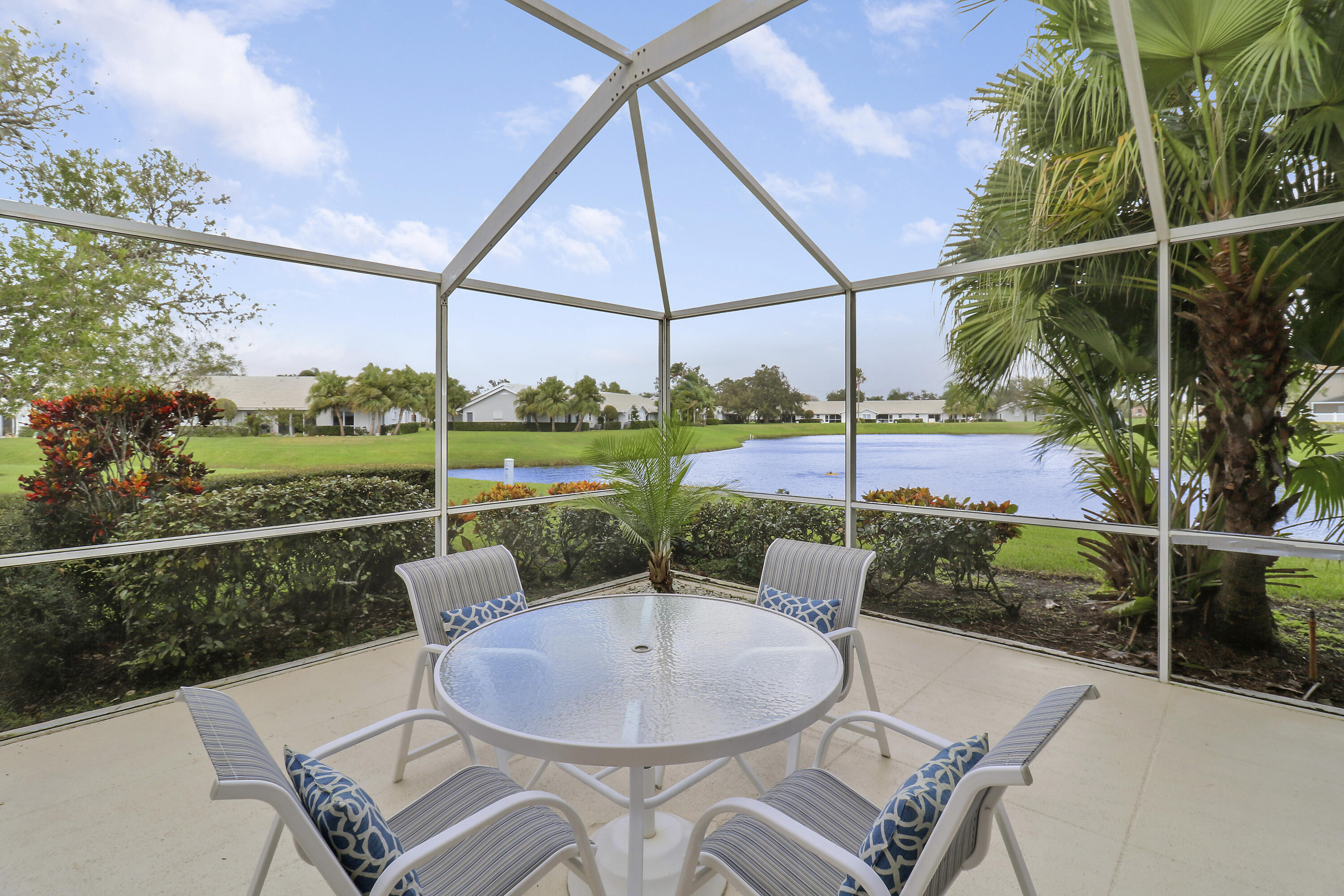 a view of a patio with a table chairs and a backyard