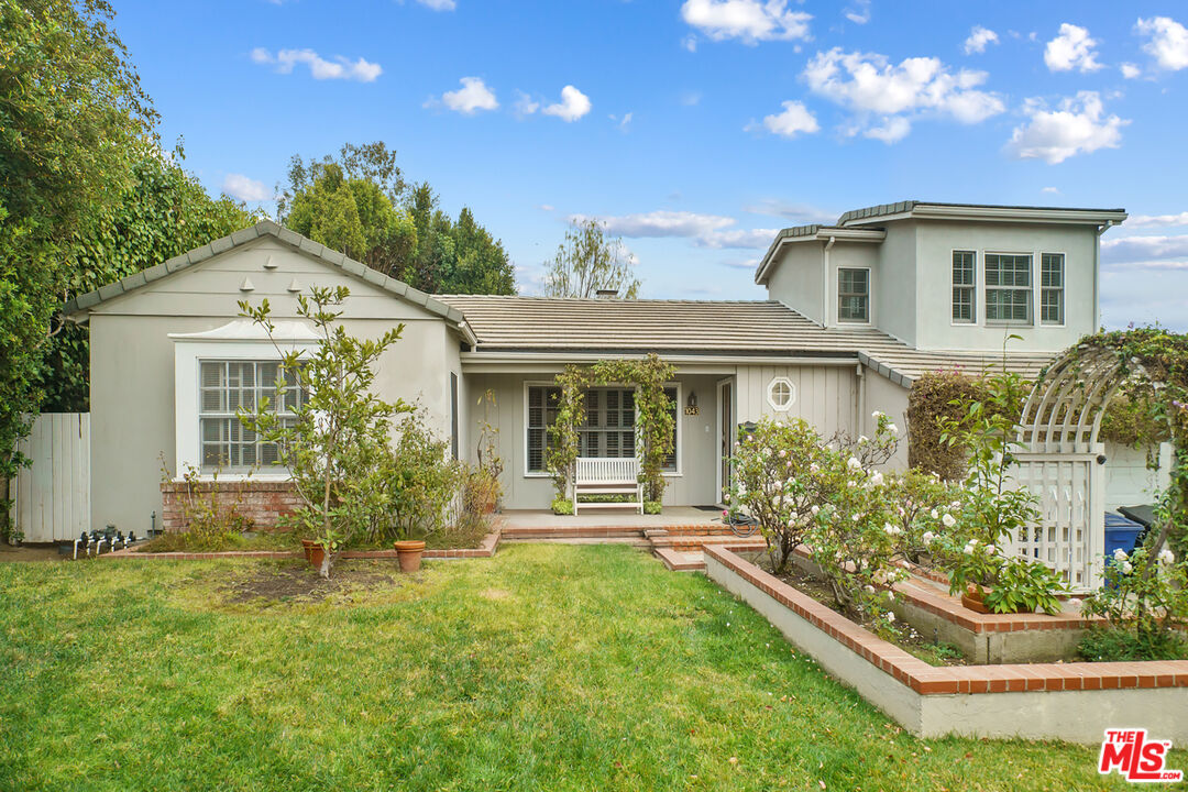 a front view of a house with garden