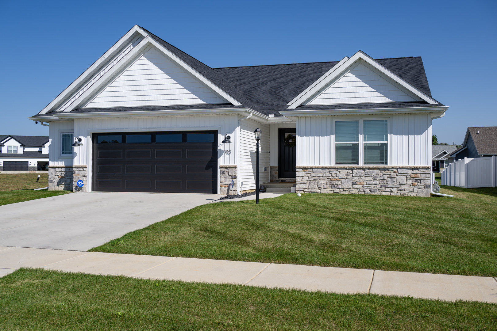 a front view of a house with a garden and yard