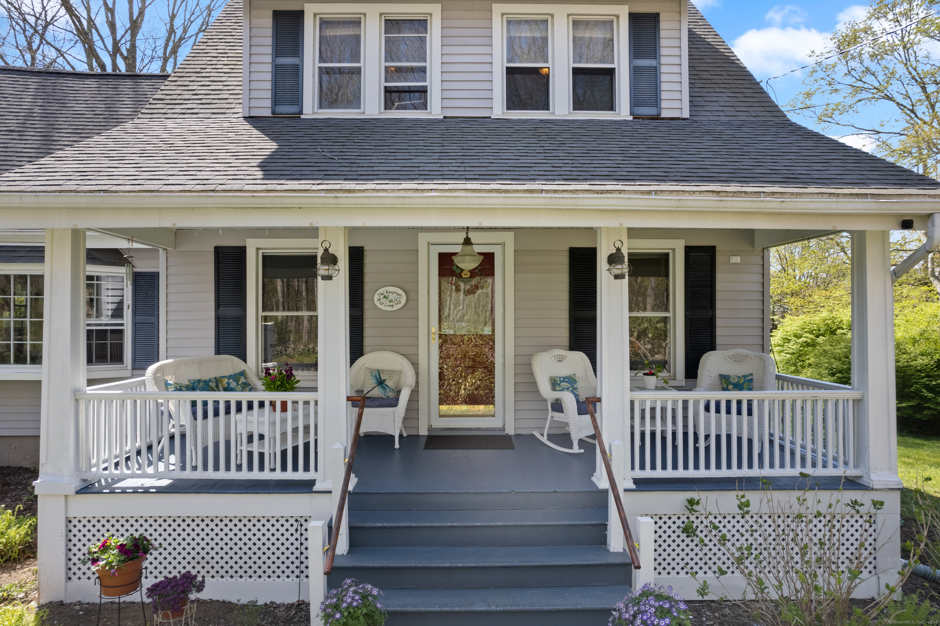 front view of a brick house with a deck