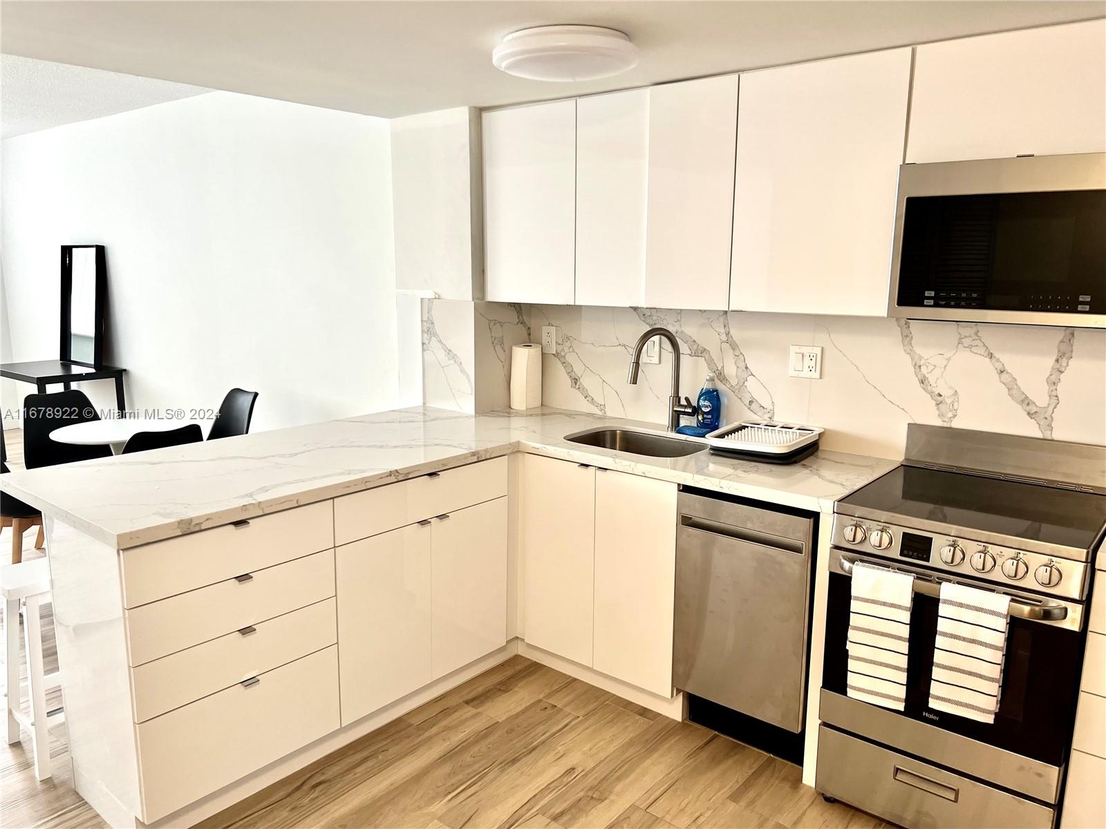 a kitchen with a sink stove and microwave