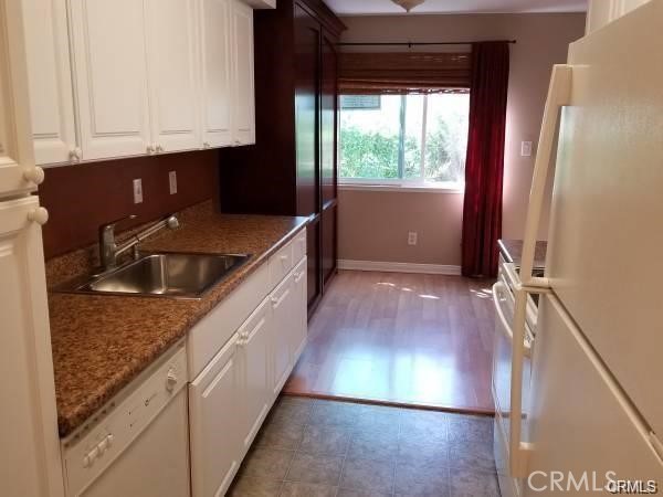 a kitchen with kitchen island granite countertop a sink stove and cabinets