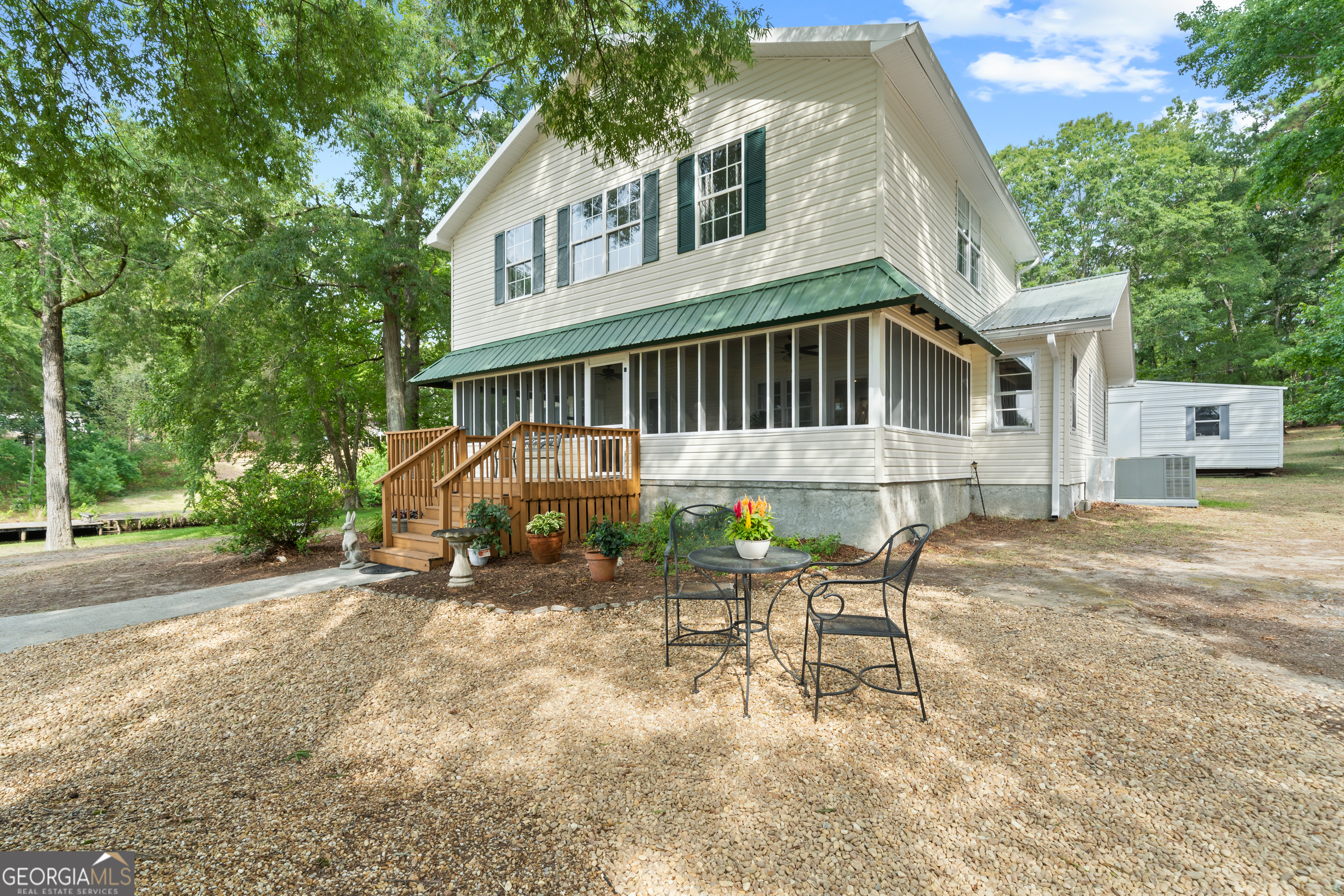 a view of a house with backyard and sitting area