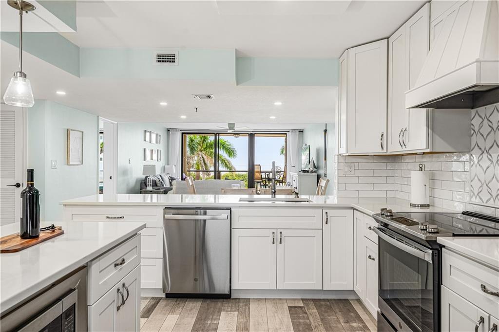 a kitchen with a sink stove and cabinets