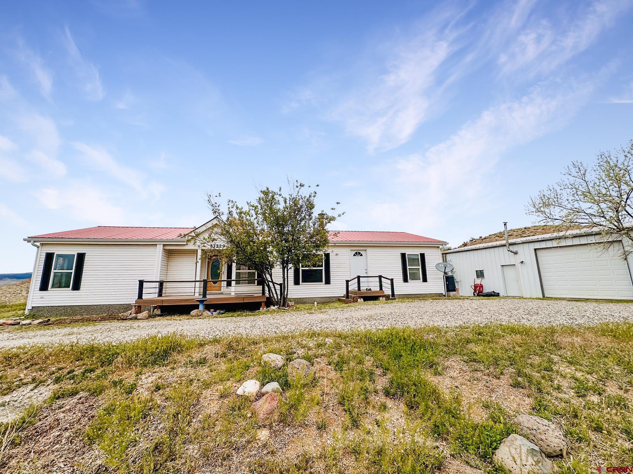 a house view with a sitting space and garden