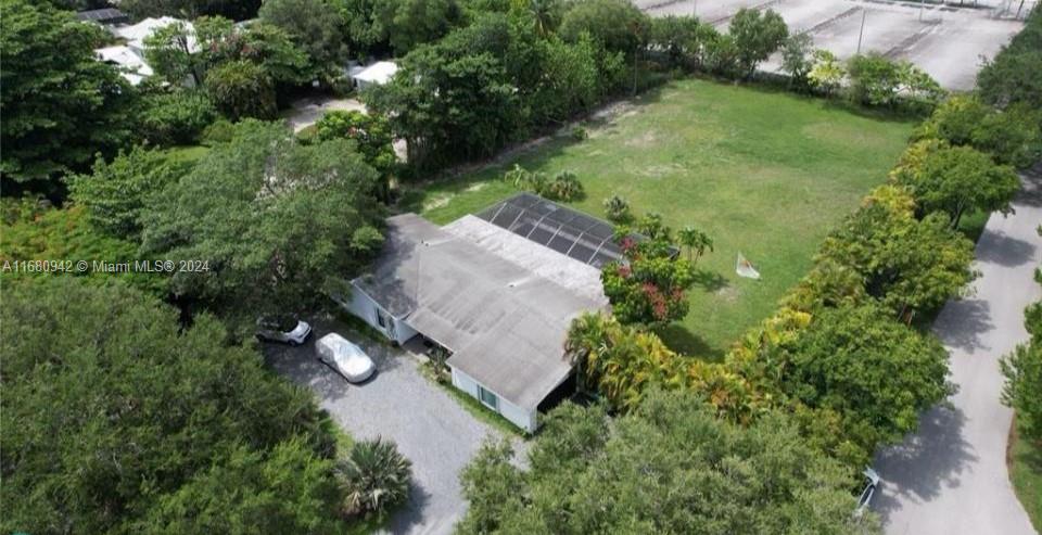 an aerial view of a house with yard