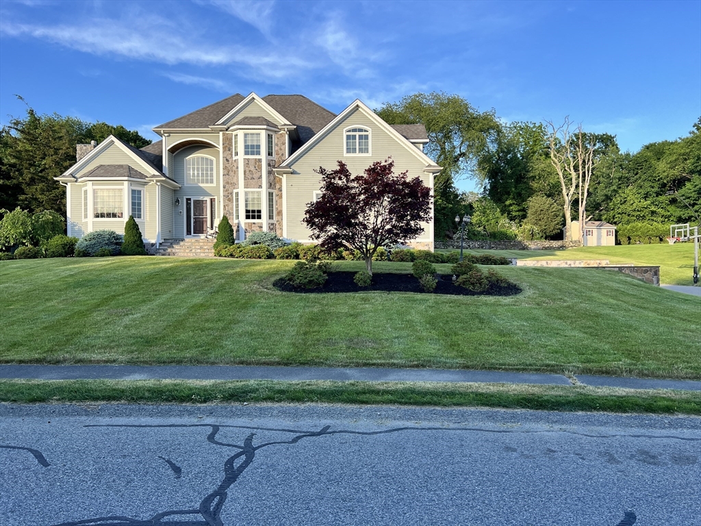 a front view of a house with a yard