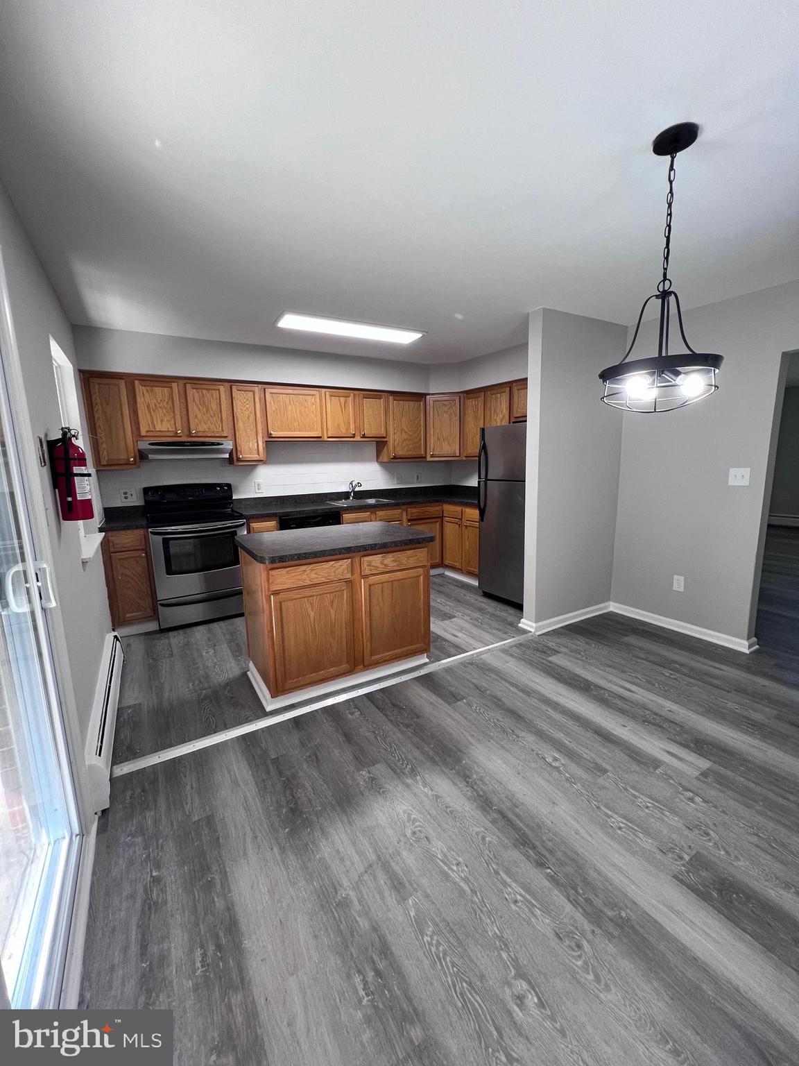 a kitchen with stainless steel appliances granite countertop a stove and a refrigerator