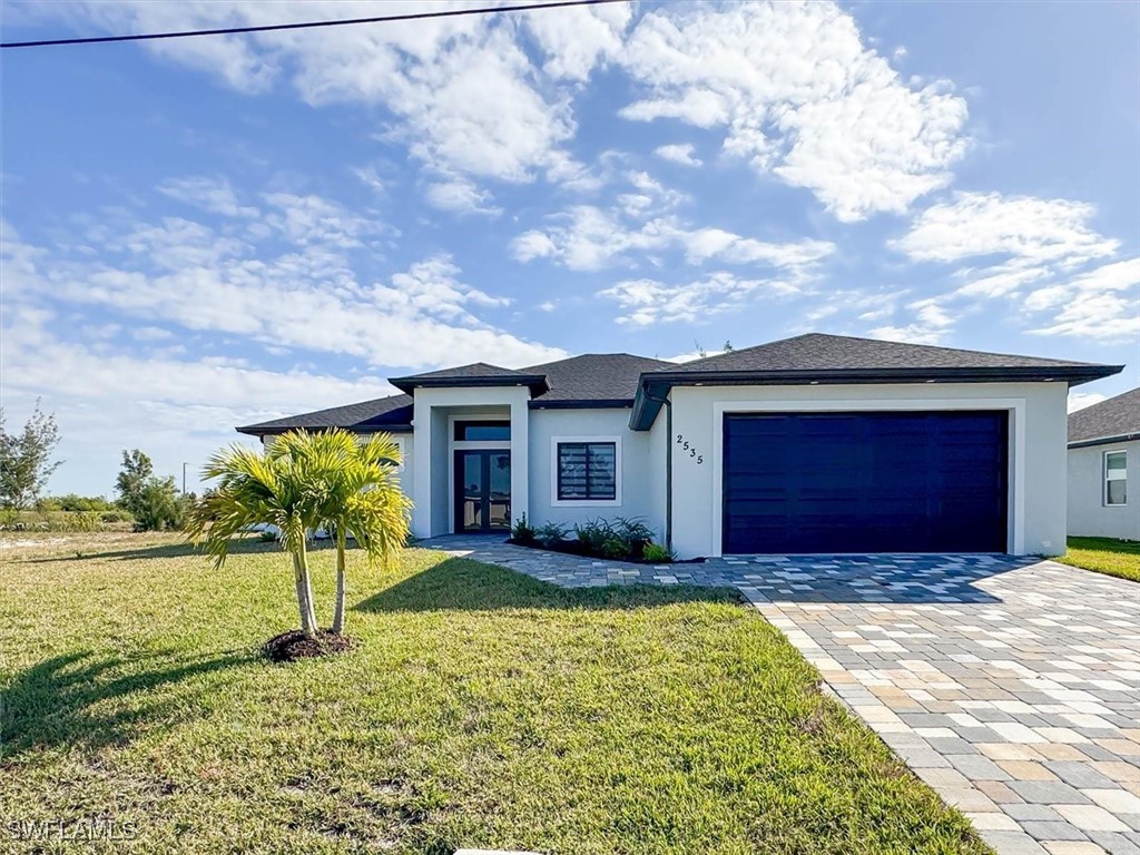 a view of a house with a yard and garage