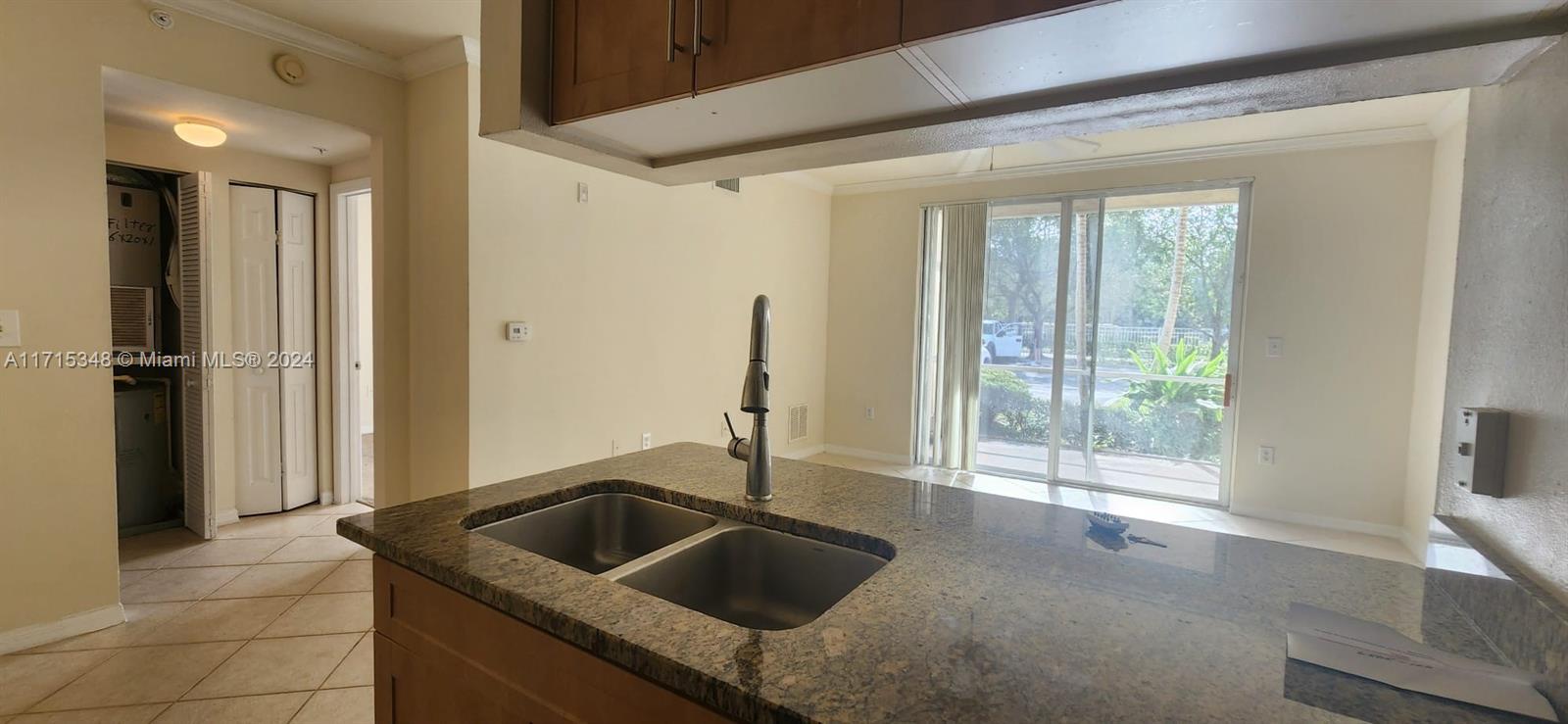 a kitchen with a sink and large window