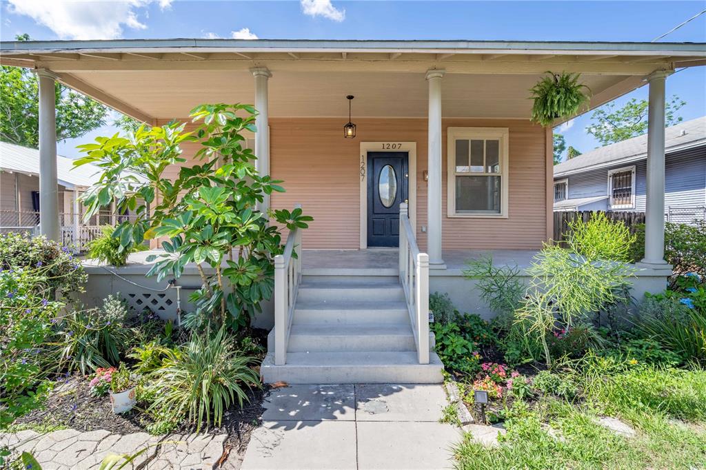 a front view of a house with plants