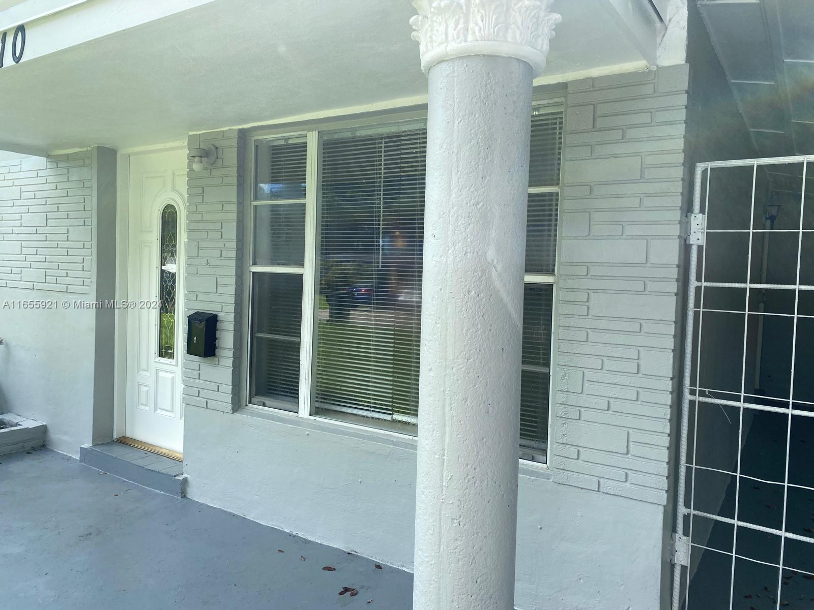 a view of potted plant in front of a door