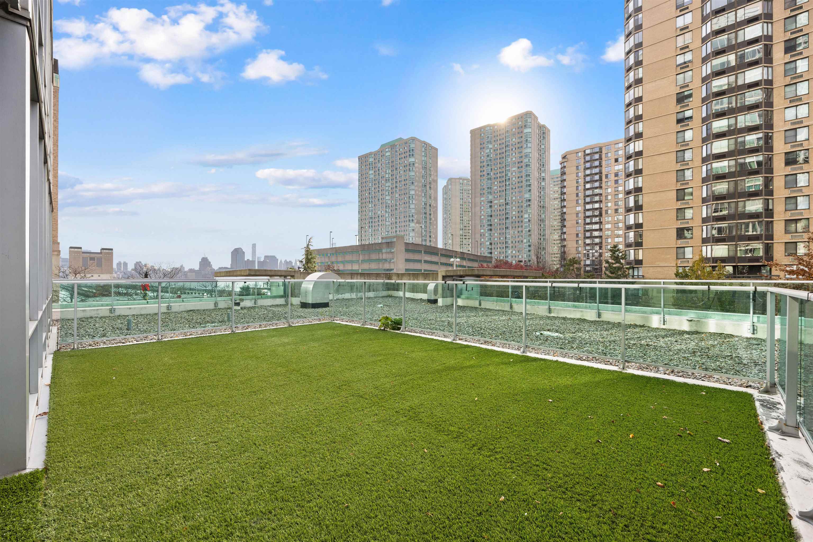 a view of a city with tall buildings and a big yard