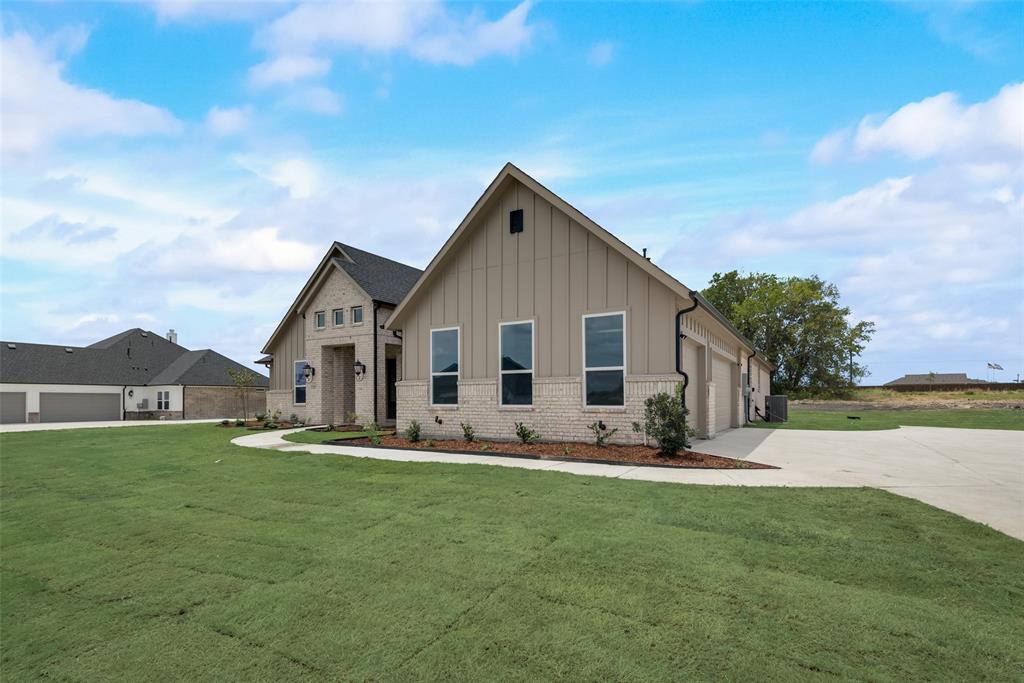 a front view of house with yard and green space