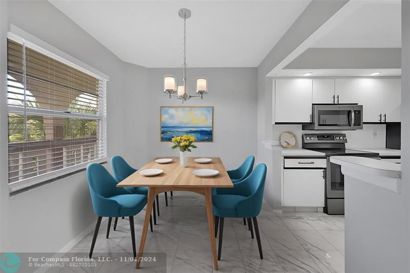 a view of a dining room with furniture a livingroom and chandelier