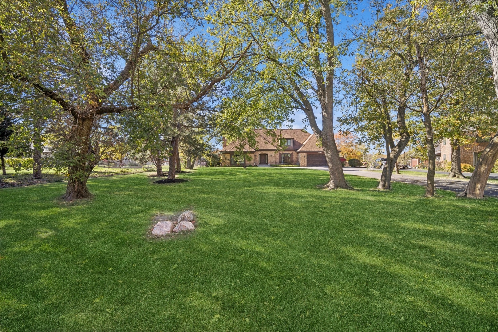 a backyard of a house with lots of green space and trees