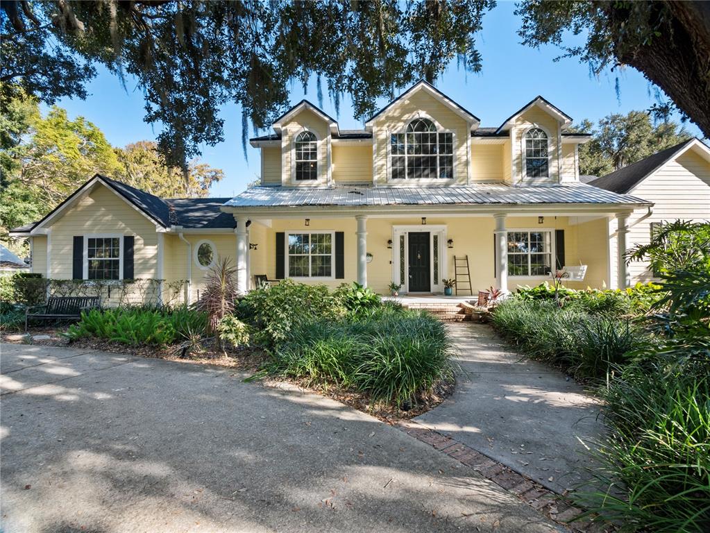 a front view of a house with a garden and porch