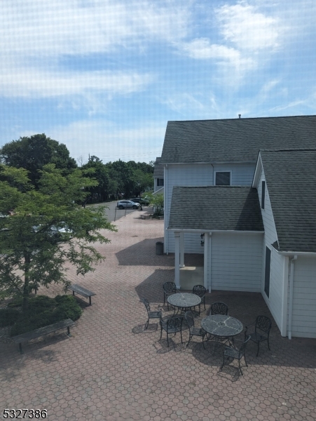 a view of a house with a yard and sitting area