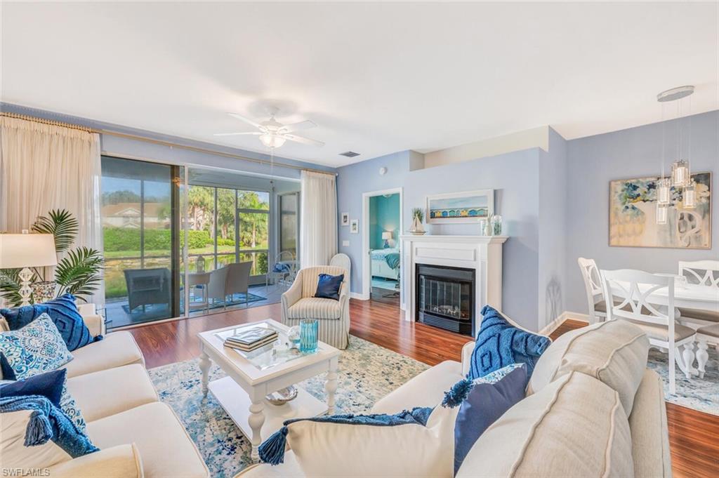 a living room with furniture fireplace and a large window