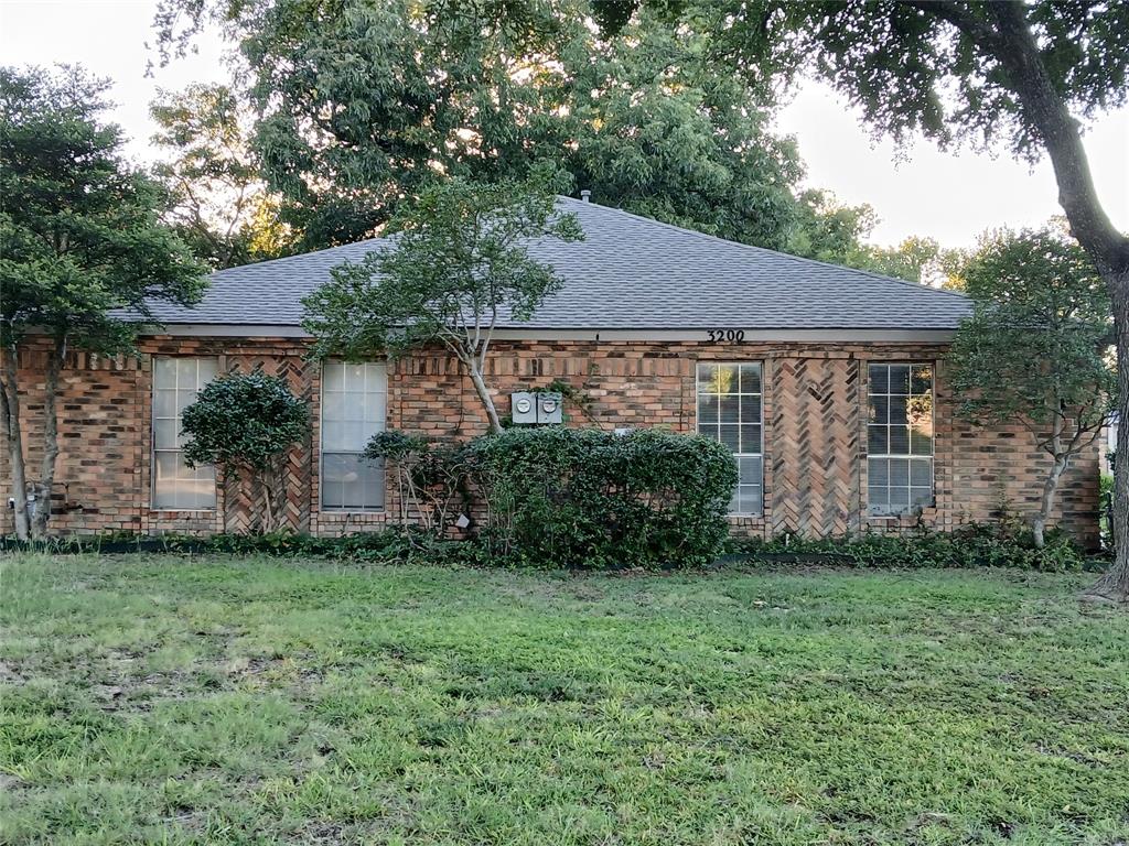 a view of a house with yard and a garden