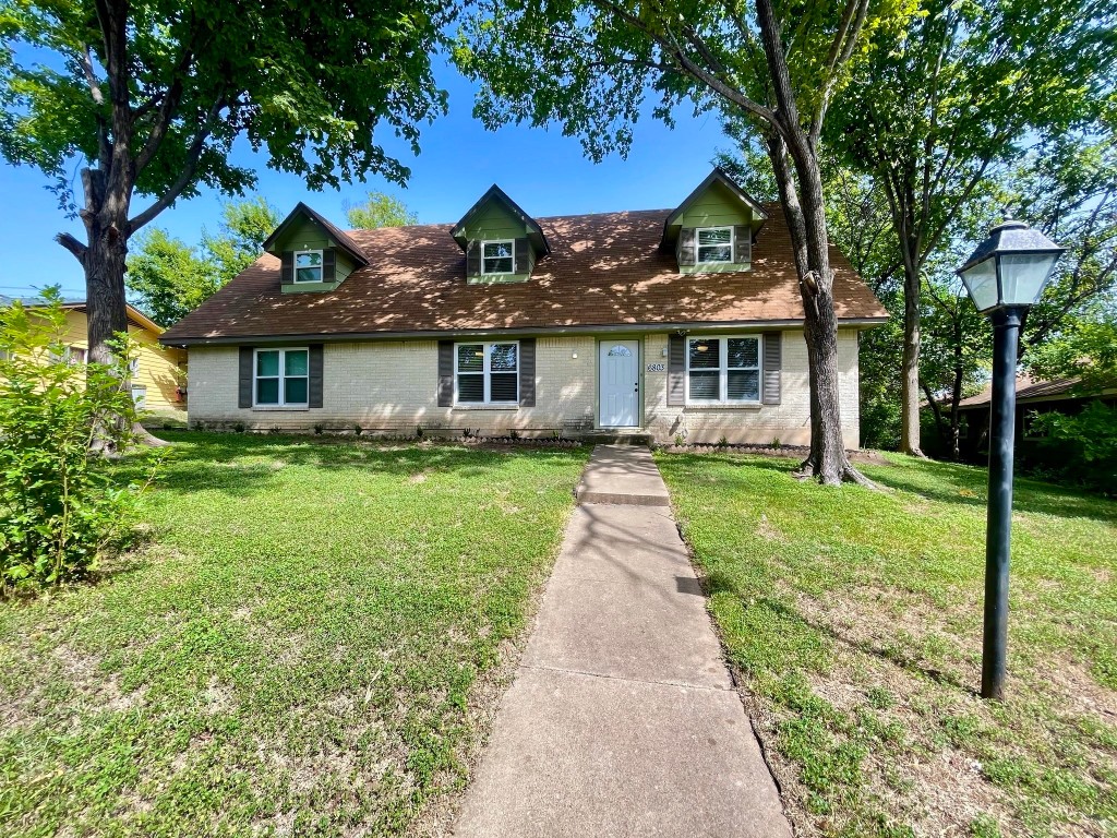 a front view of house with yard and green space