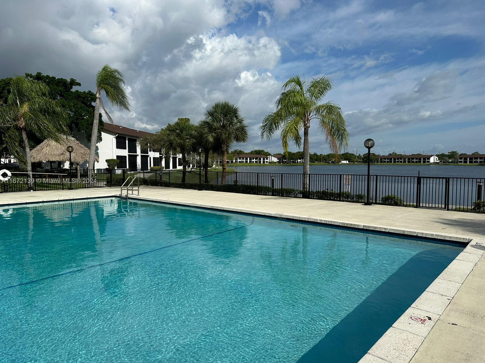 a view of swimming pool with outdoor seating and plants