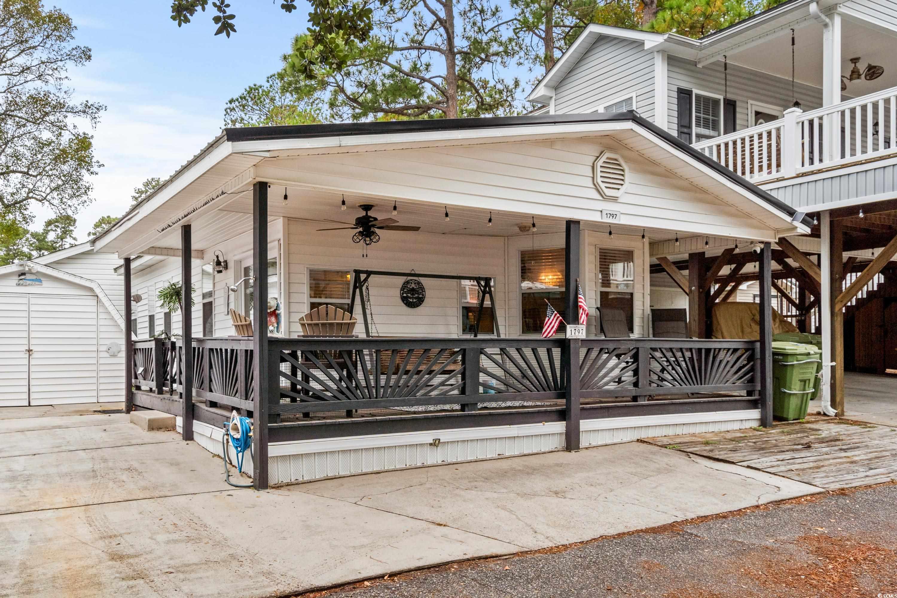 Exterior space with an outbuilding, covered porch,