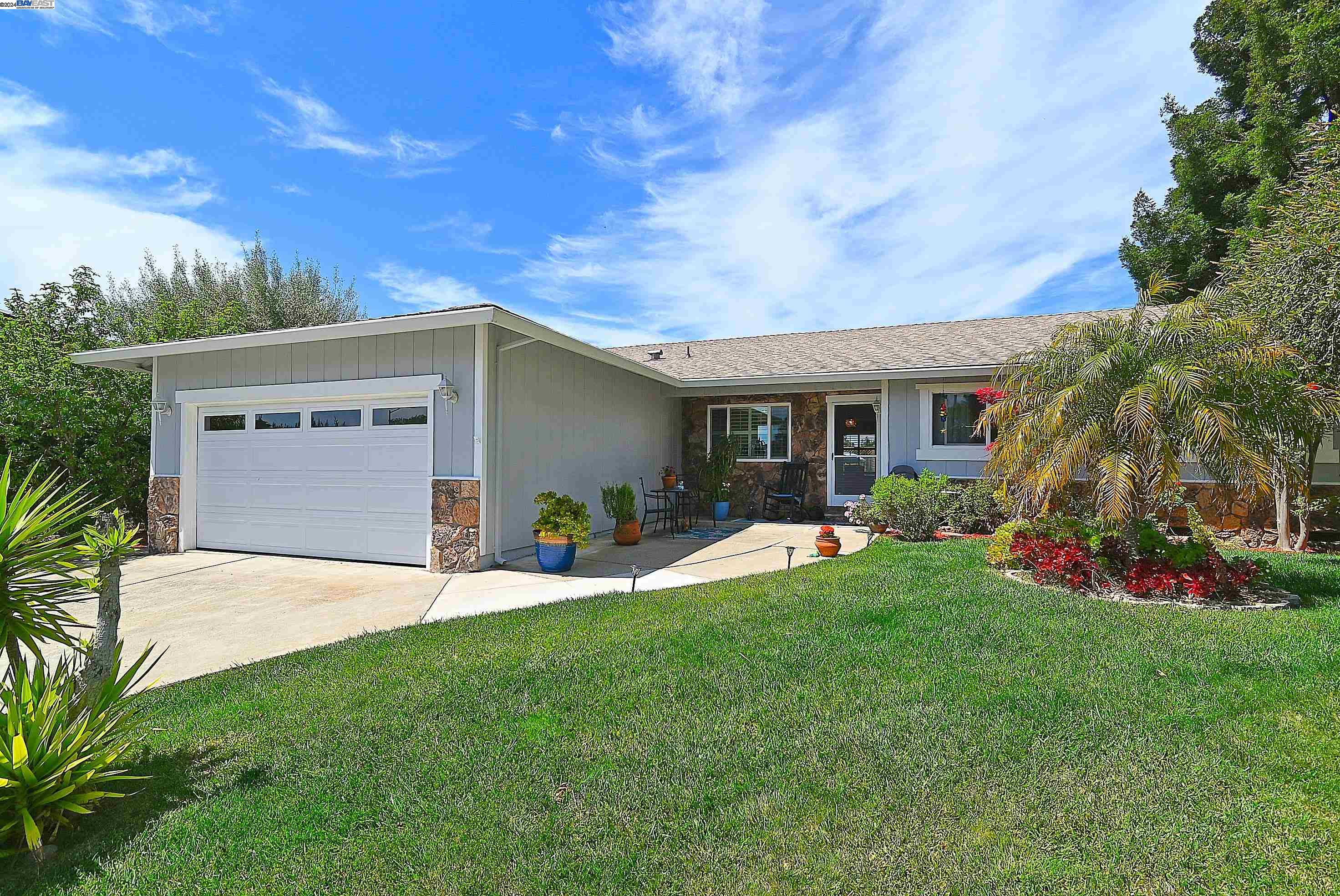 a front view of house with yard and outdoor seating