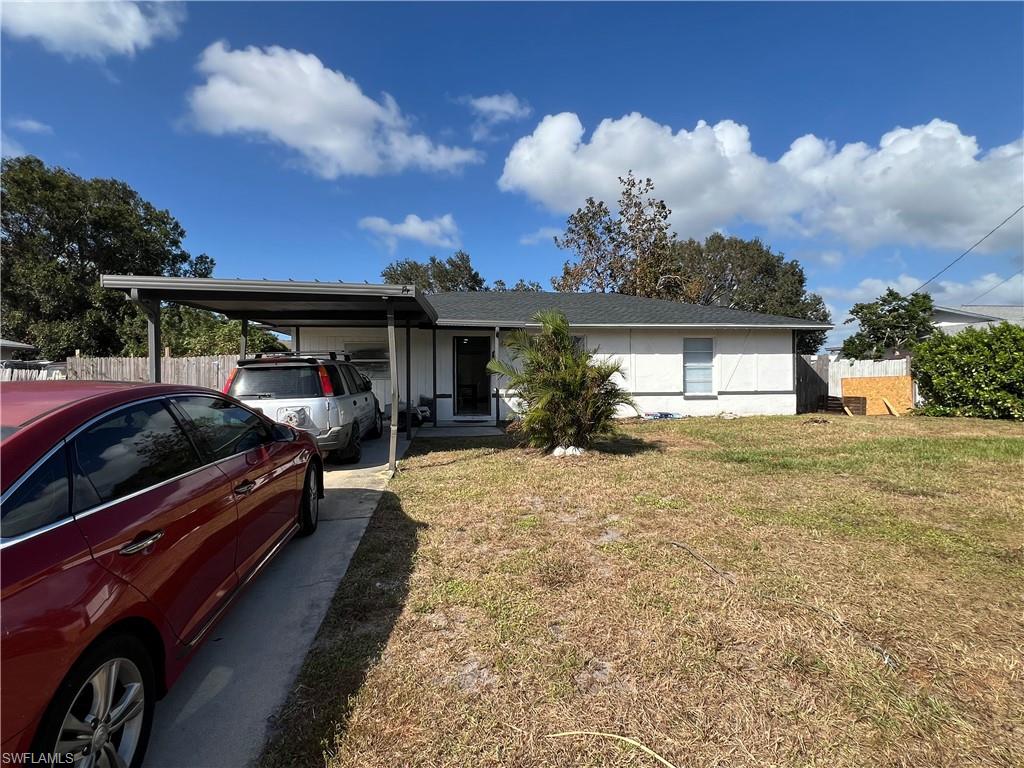 a view of a house with backyard and porch