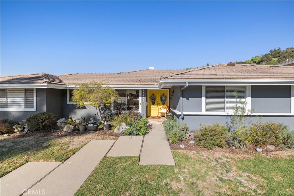 a front view of a house with a yard and sitting space