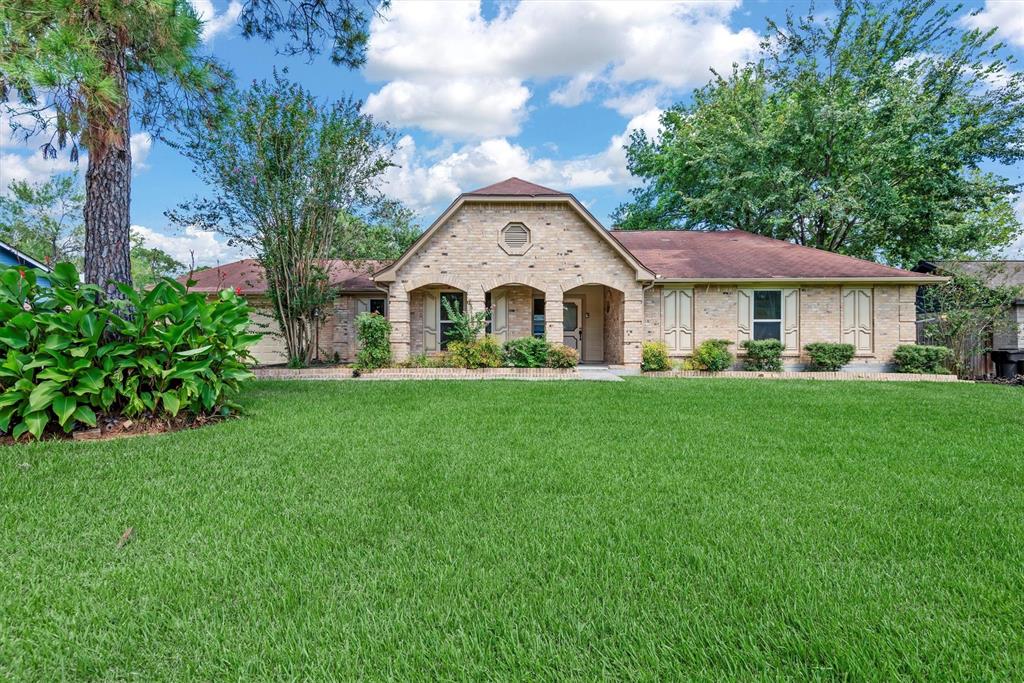 a front view of a house with a garden and yard