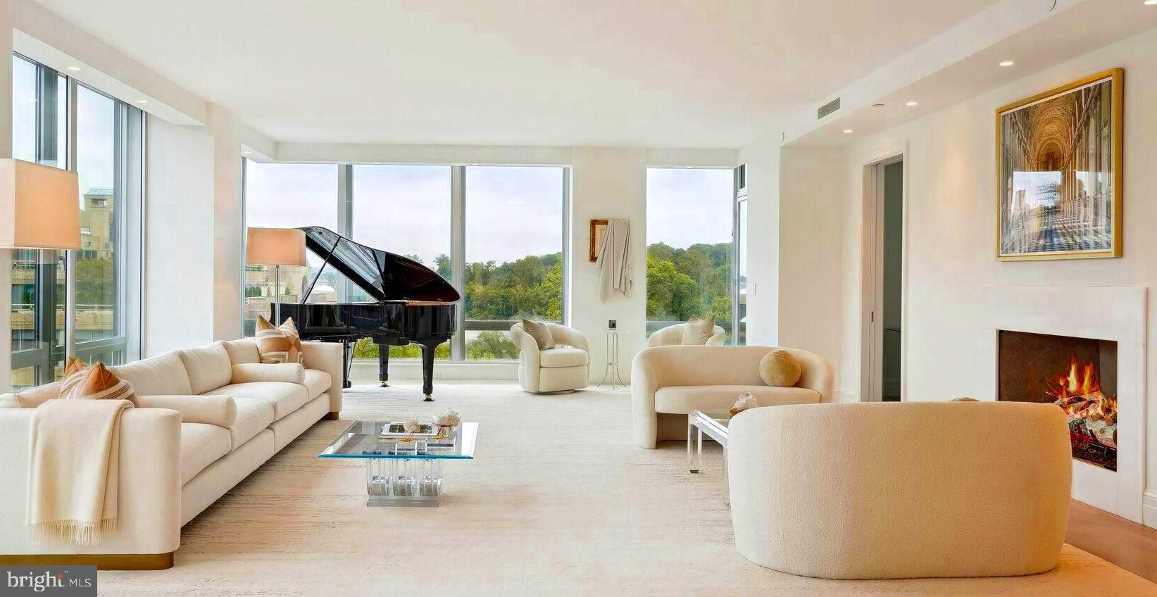 a living room with furniture and large windows