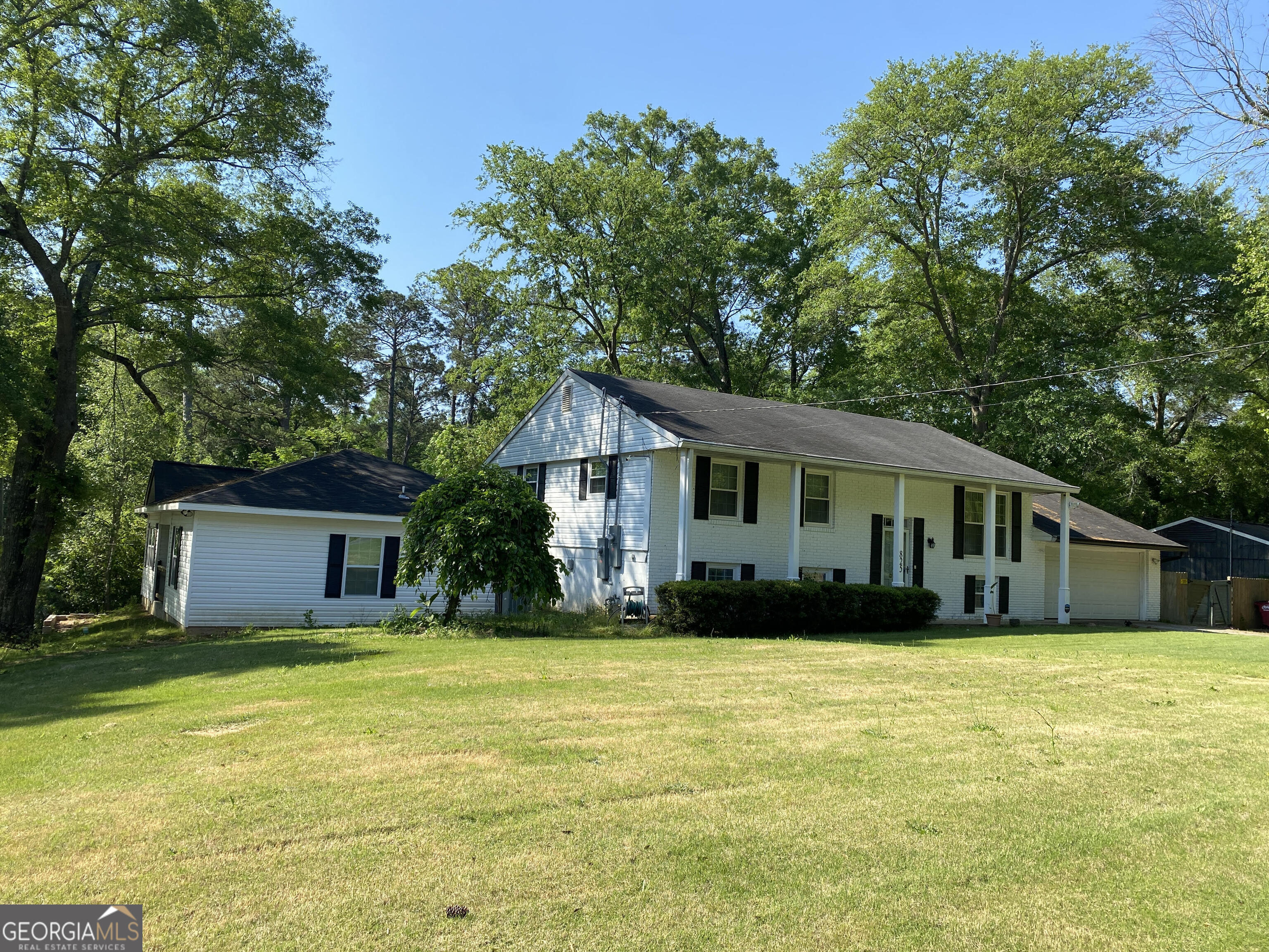 a front view of house with yard and green space