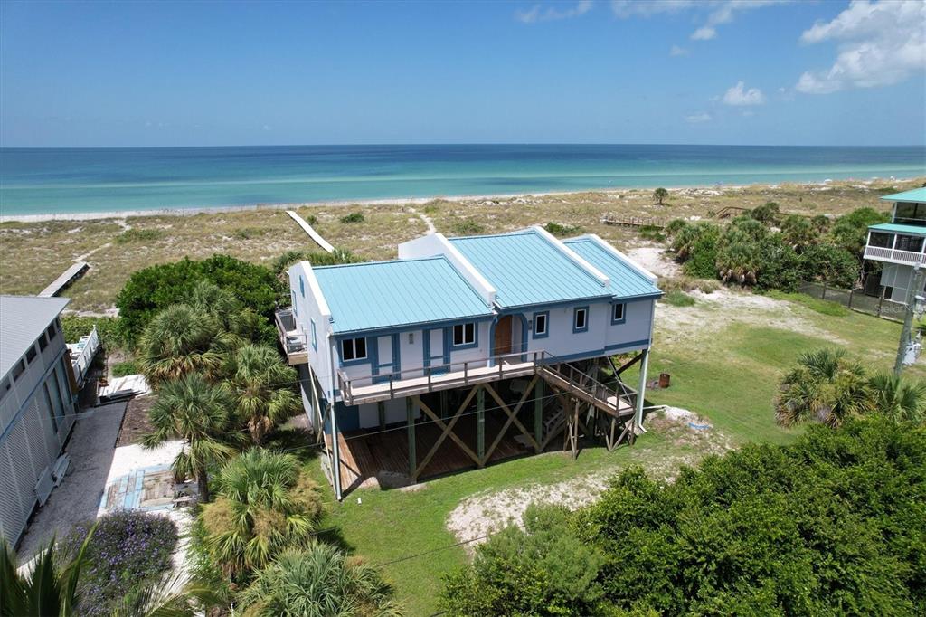 an aerial view of house with ocean view