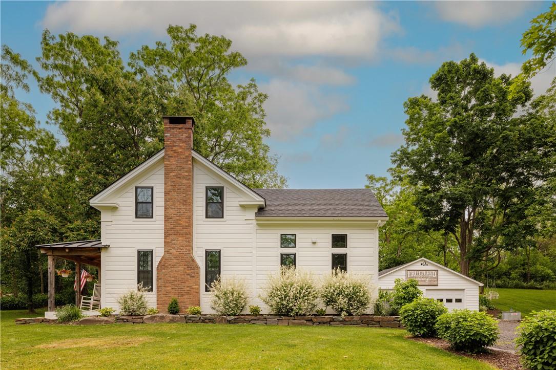 a front view of house with yard and green space