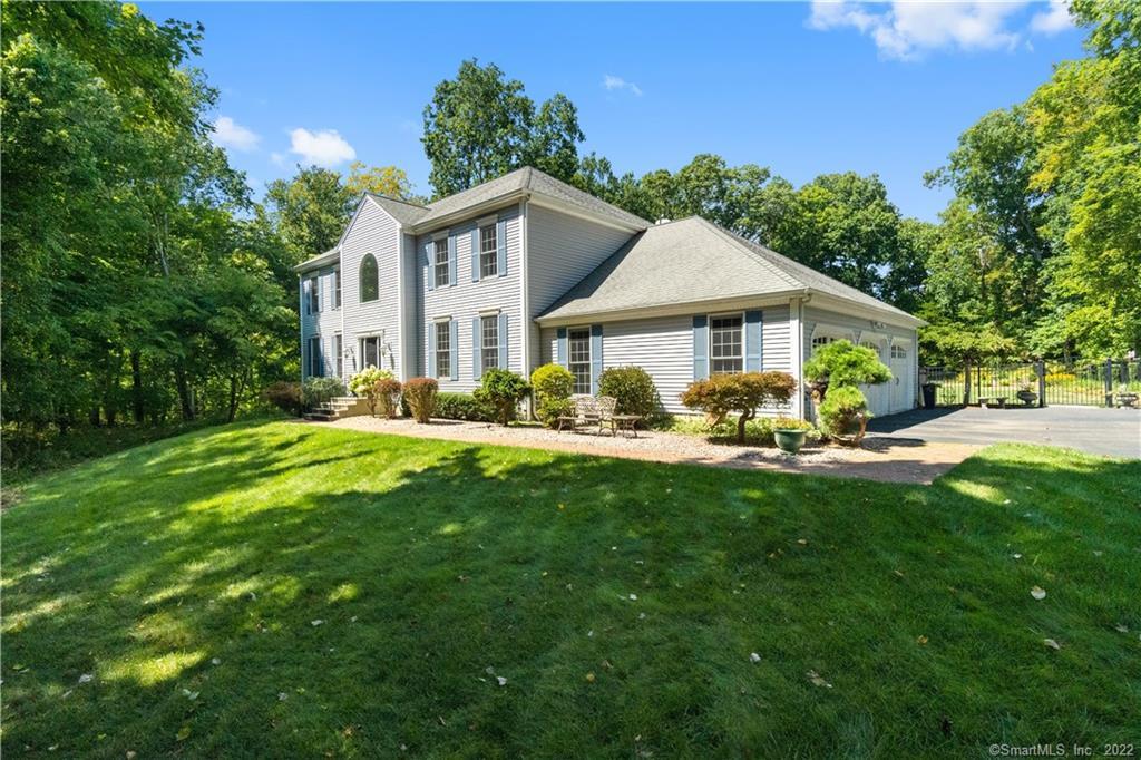 a front view of a house with yard and green space