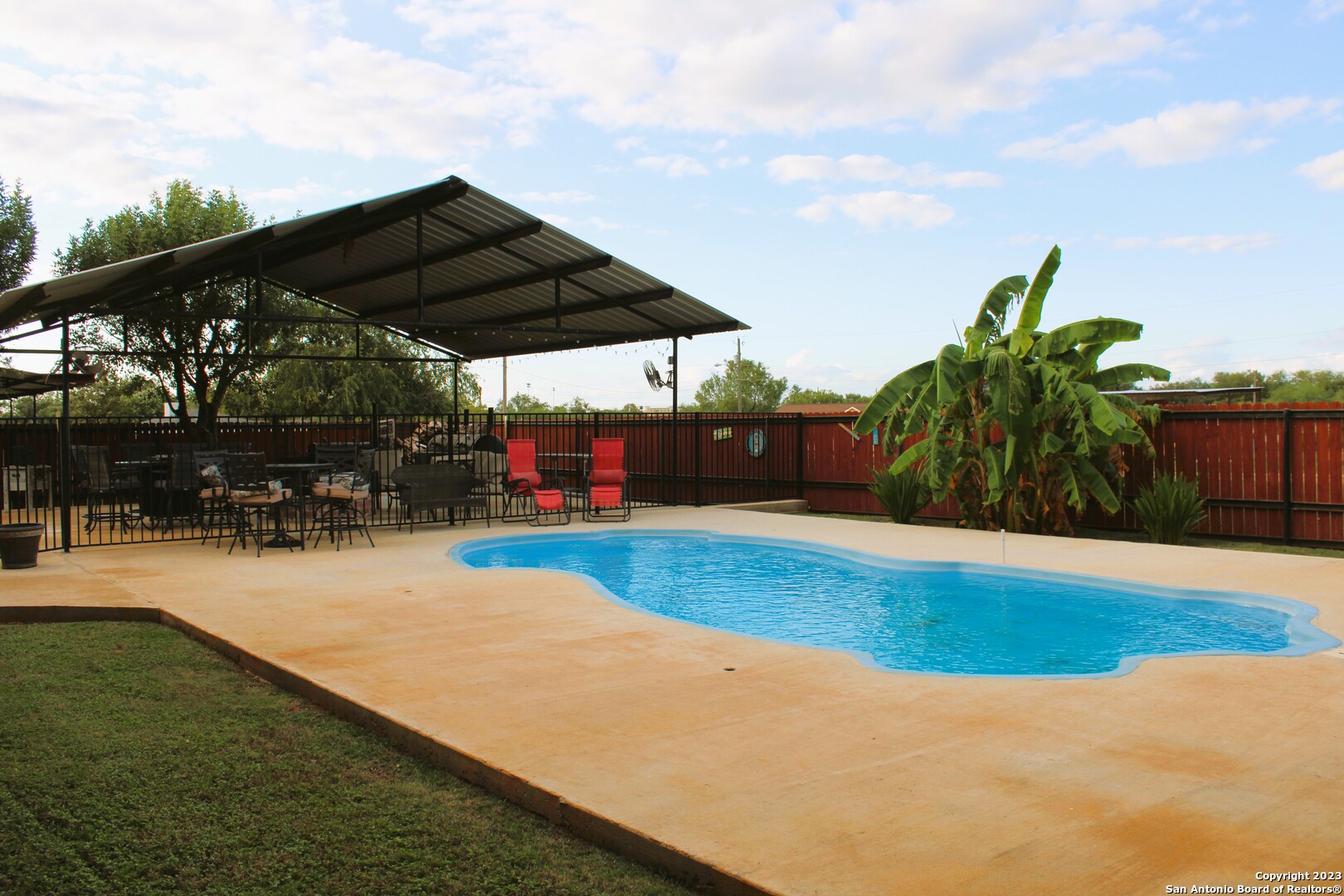 a view of swimming pool with sitting area