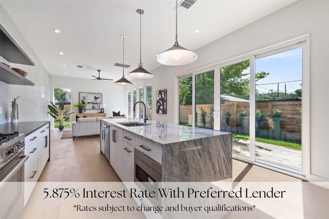 a large white kitchen with a large window