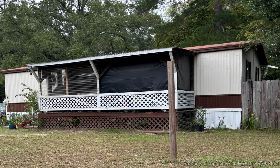 a side view of a house with a gate