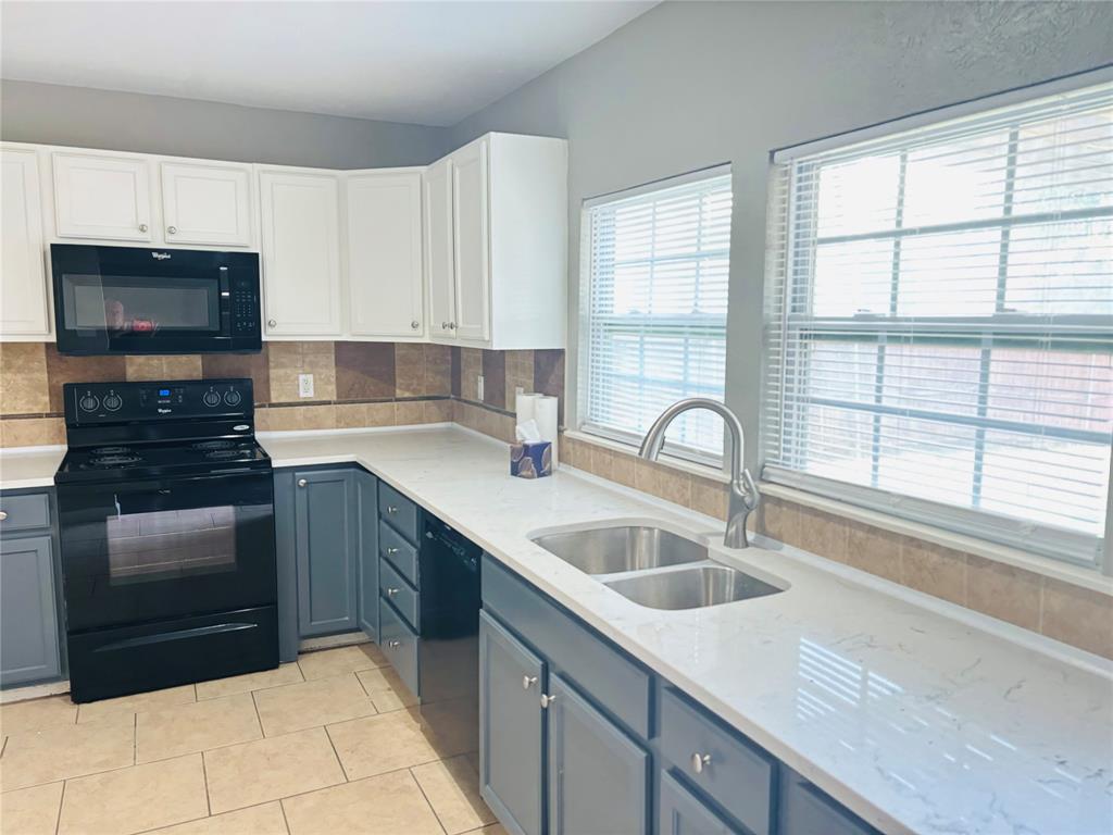 a kitchen with a sink and a stove top oven