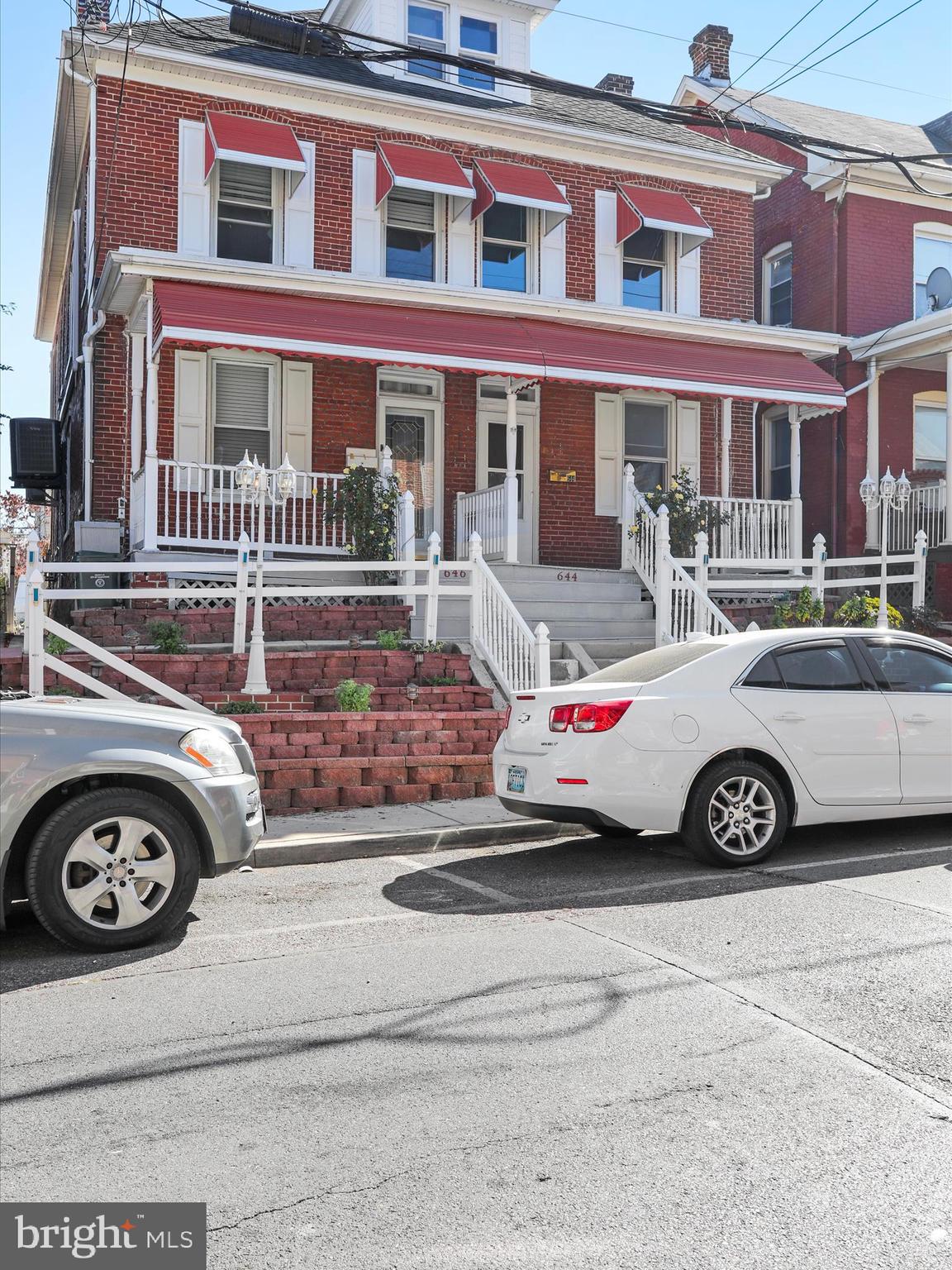 a front view of a house with parking space