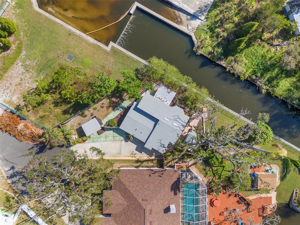 an aerial view of a house with a yard and lake view