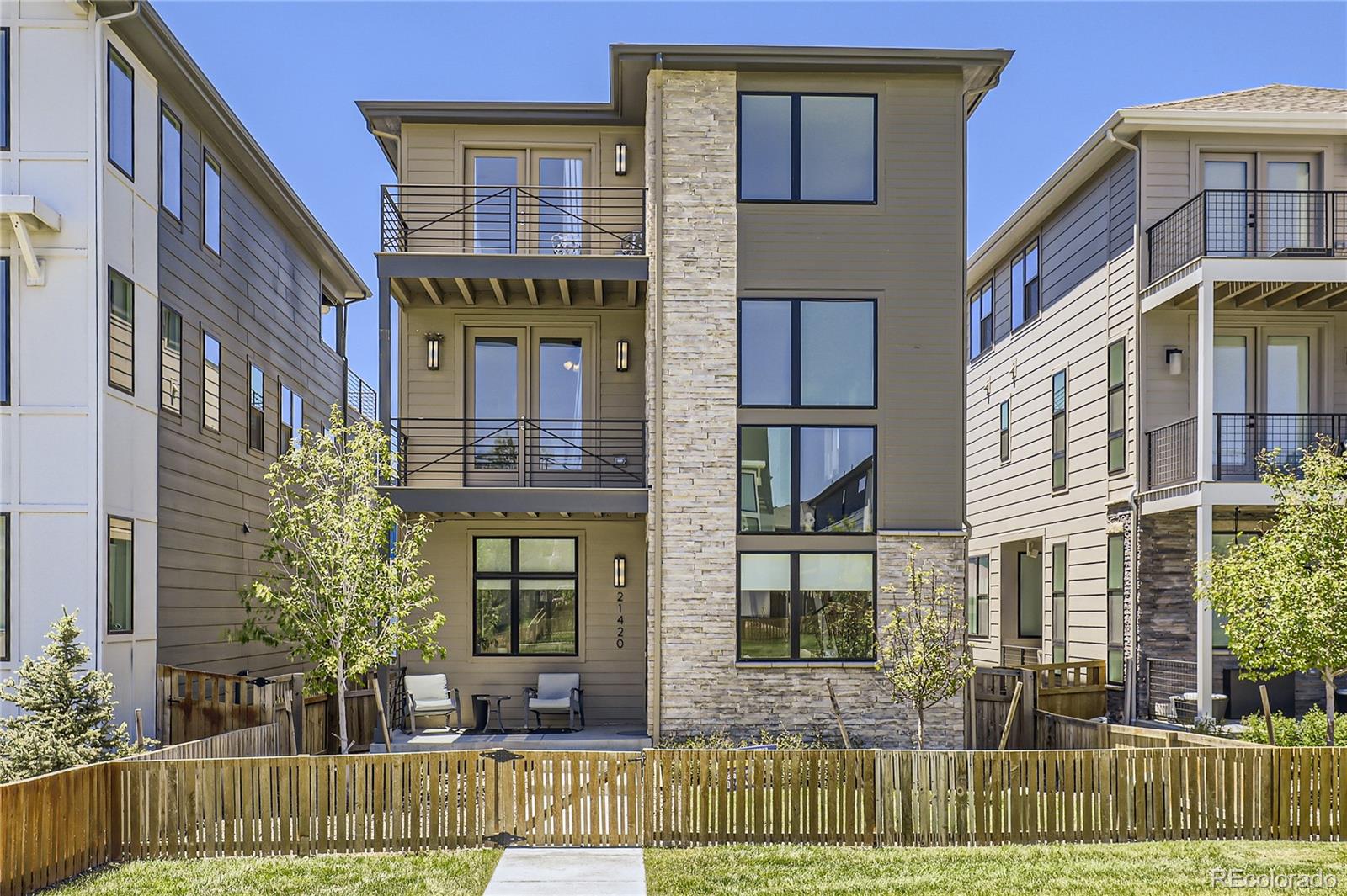 a front view of a residential apartment building with a yard