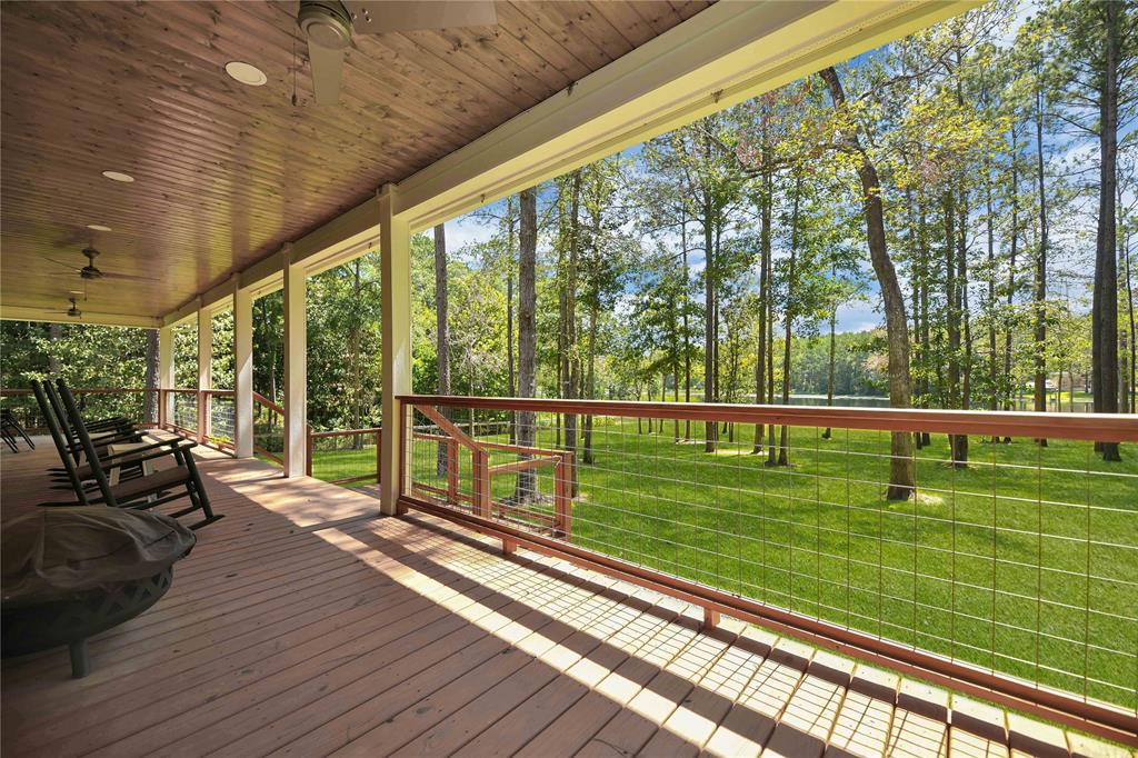 a view of a balcony with lake view and a wooden floor